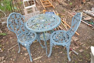 A CAST ALUMINIUM GARDEN TABLE 67cm in diameter, and a pair of matching chairs with grape and vine