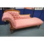 A LATE VICTORIAN WALNUT AND INLAID CHAISE LOUNGE, with pink and floral upholstery, raised on