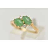 AN 18CT GOLD JADE AND DIAMOND RING, of crossover design, claw set horizontally with two oval jade