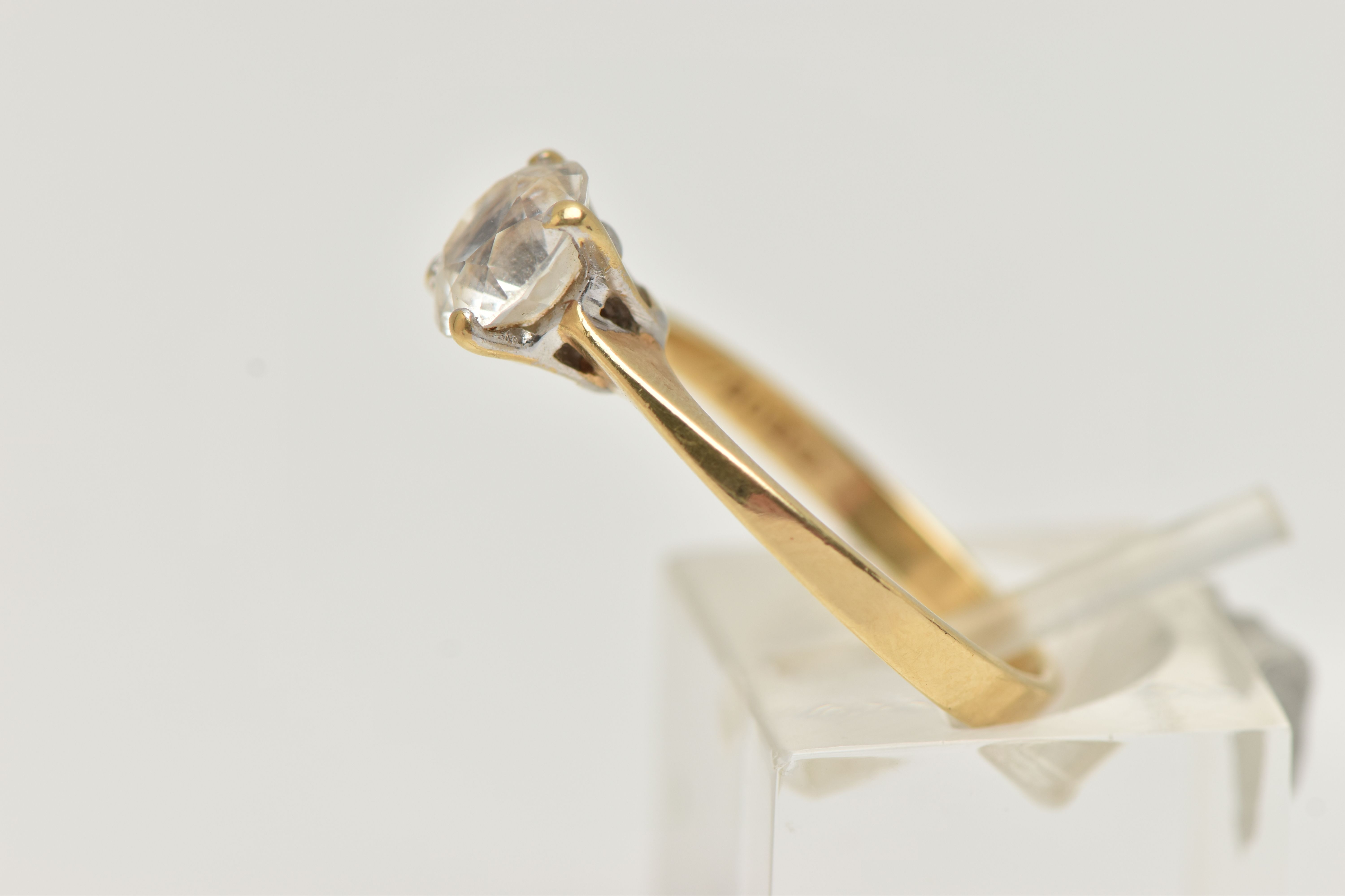 A YELLOW METAL TOPAZ RING, set with a circular cut colourless topaz, in a four claw setting, pinched - Image 2 of 4