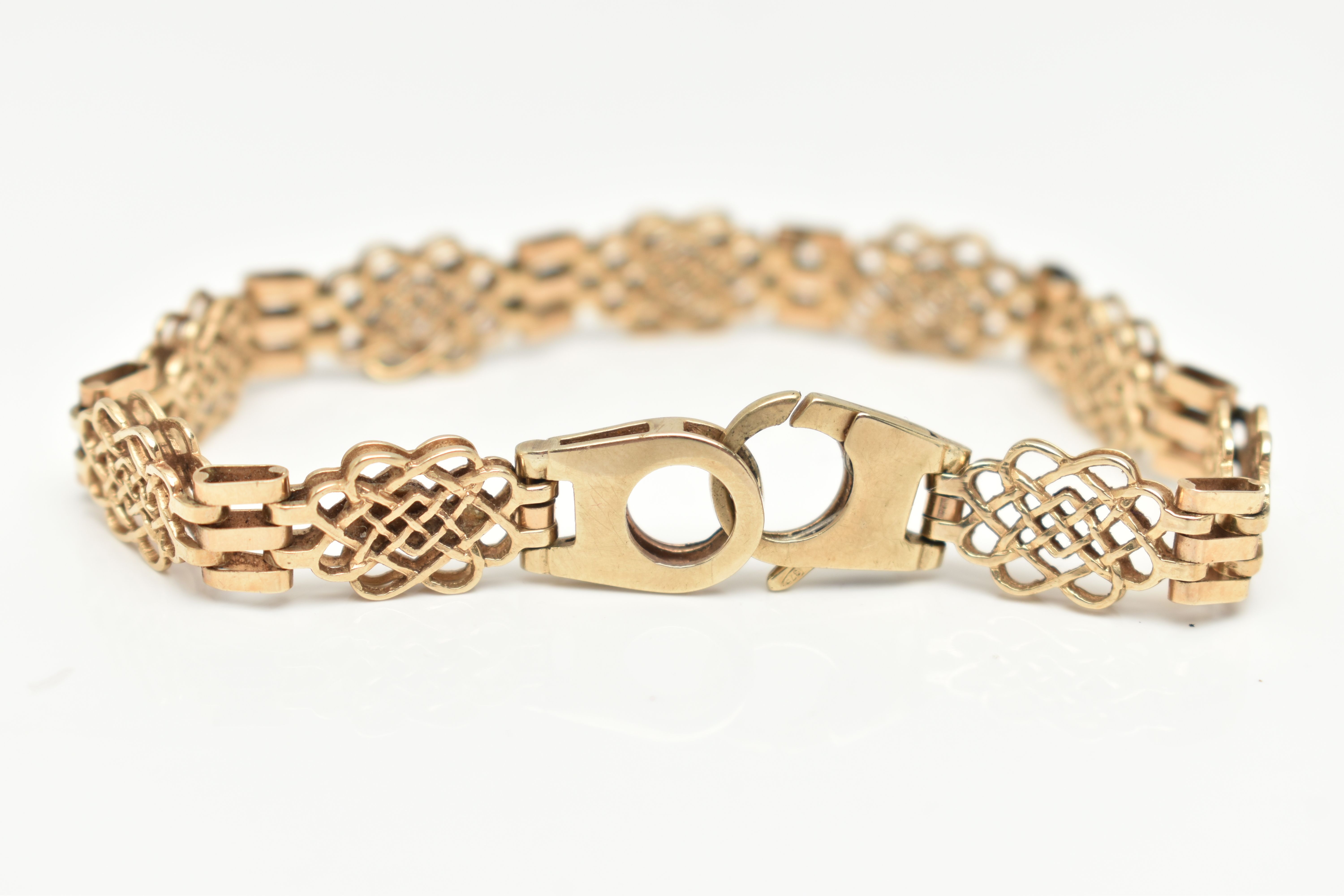 A 9CT GOLD FANCY LINK BRACELET, open work links interspaced with three bar links, fitted with a - Image 2 of 2