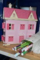 A MODERN WOODEN DOLLS HOUSE, pink with white trim, front opening to reveal two rooms over two