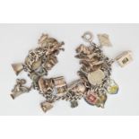 A WHITE METAL CHARM BRACELET AND CHARMS, a curb link bracelet fitted with a spring clasp,