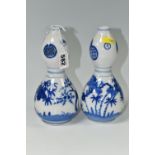 A PAIR OF JAPANESE DOUBLE GOURD VASES, painted in blue with trees and foliage, unmarked, height