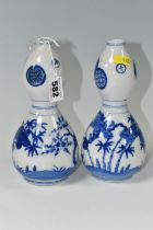 A PAIR OF JAPANESE DOUBLE GOURD VASES, painted in blue with trees and foliage, unmarked, height