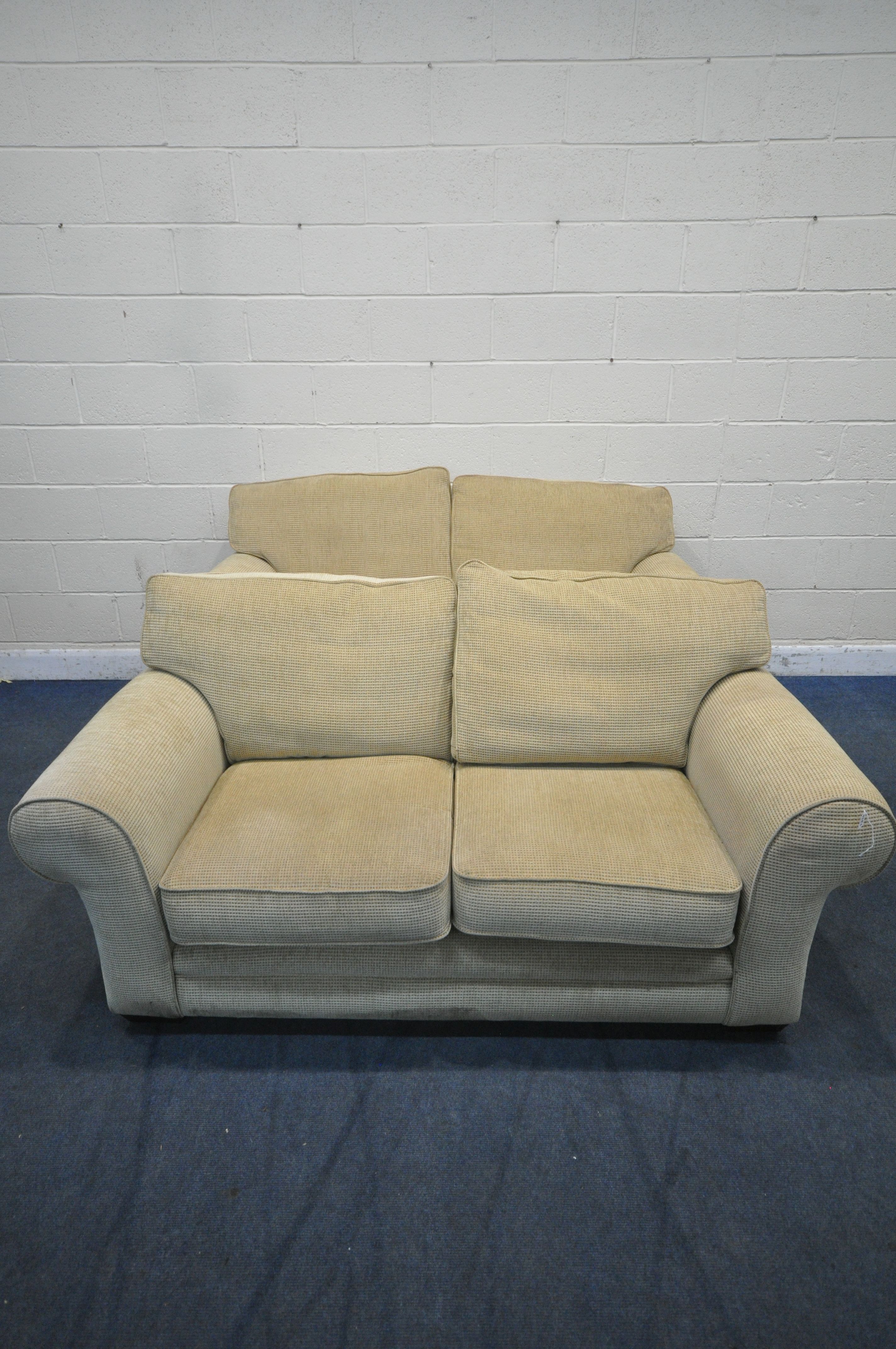 A PAIR OF BEIGE UPHOLSTERED TWO SEATER SOFAS, length 180cm x depth 94cm x height 84cm (condition