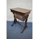 A VICTORIAN ROSEWOOD WORK TABLE, with a hinged lid, that's enclosing various divisions, raised on