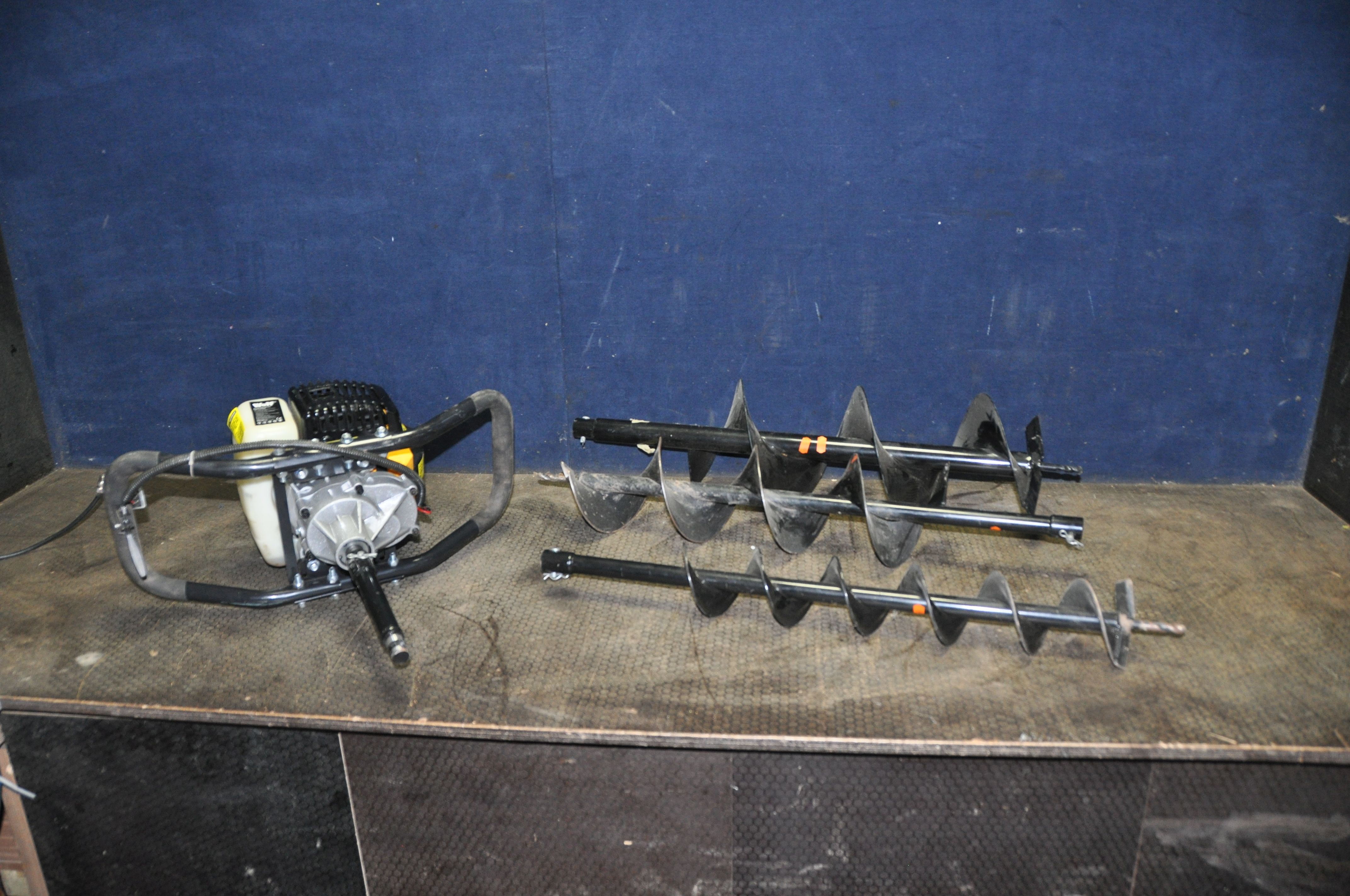 A WOLF 52CC PETROL EARTH AUGER with three sizes of auger (engine pulls freely but hasn't started)