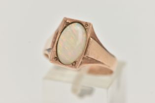A YELLOW METAL OPAL RING, set with an oval cut white opal cabochon, measuring approximately length