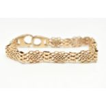 A 9CT GOLD FANCY LINK BRACELET, open work links interspaced with three bar links, fitted with a
