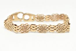 A 9CT GOLD FANCY LINK BRACELET, open work links interspaced with three bar links, fitted with a