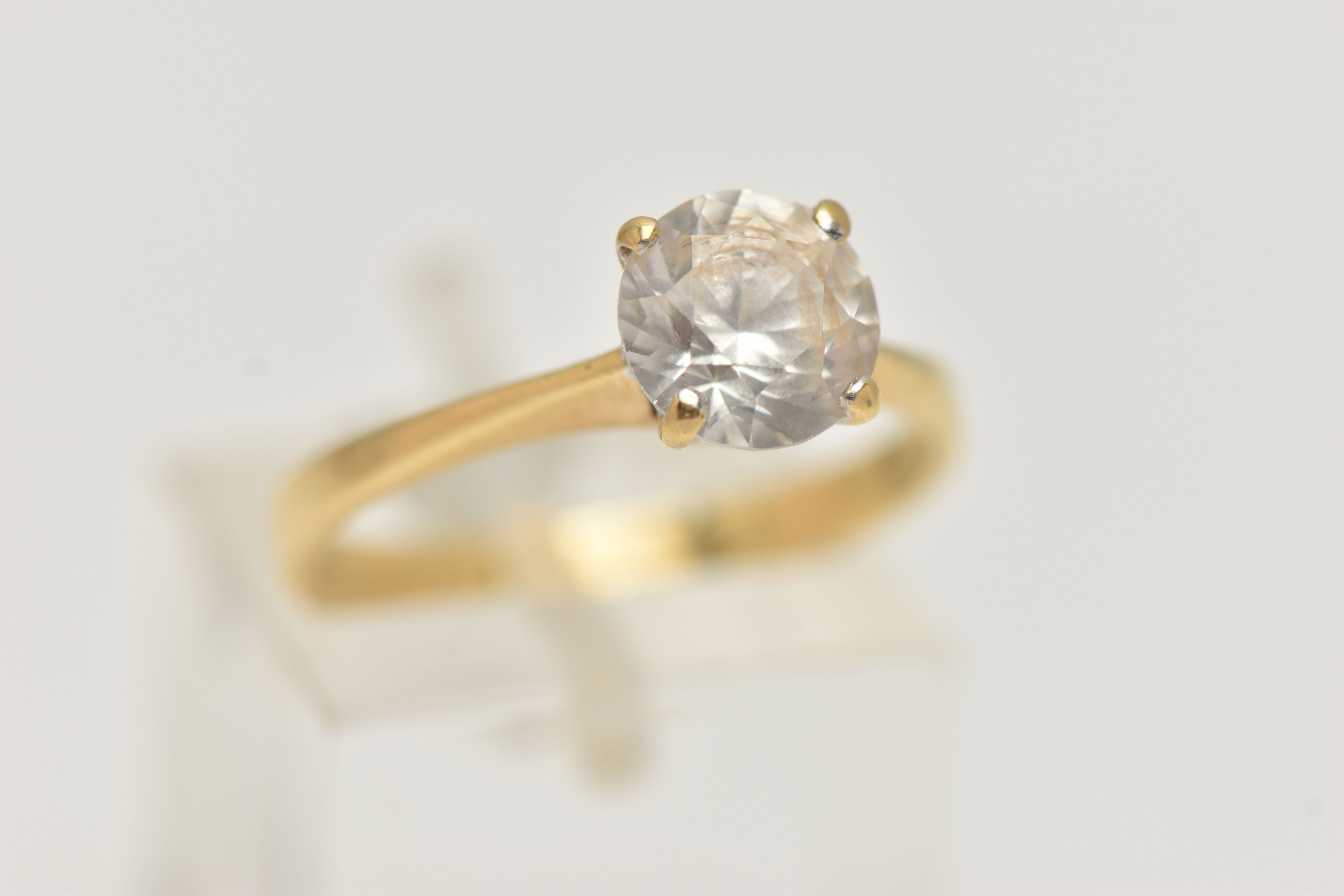 A YELLOW METAL TOPAZ RING, set with a circular cut colourless topaz, in a four claw setting, pinched - Image 4 of 4