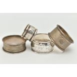 FOUR NAPKIN RINGS, to include an engine turned pattern napkin ring with engraved cartouche,