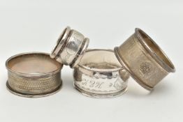 FOUR NAPKIN RINGS, to include an engine turned pattern napkin ring with engraved cartouche,