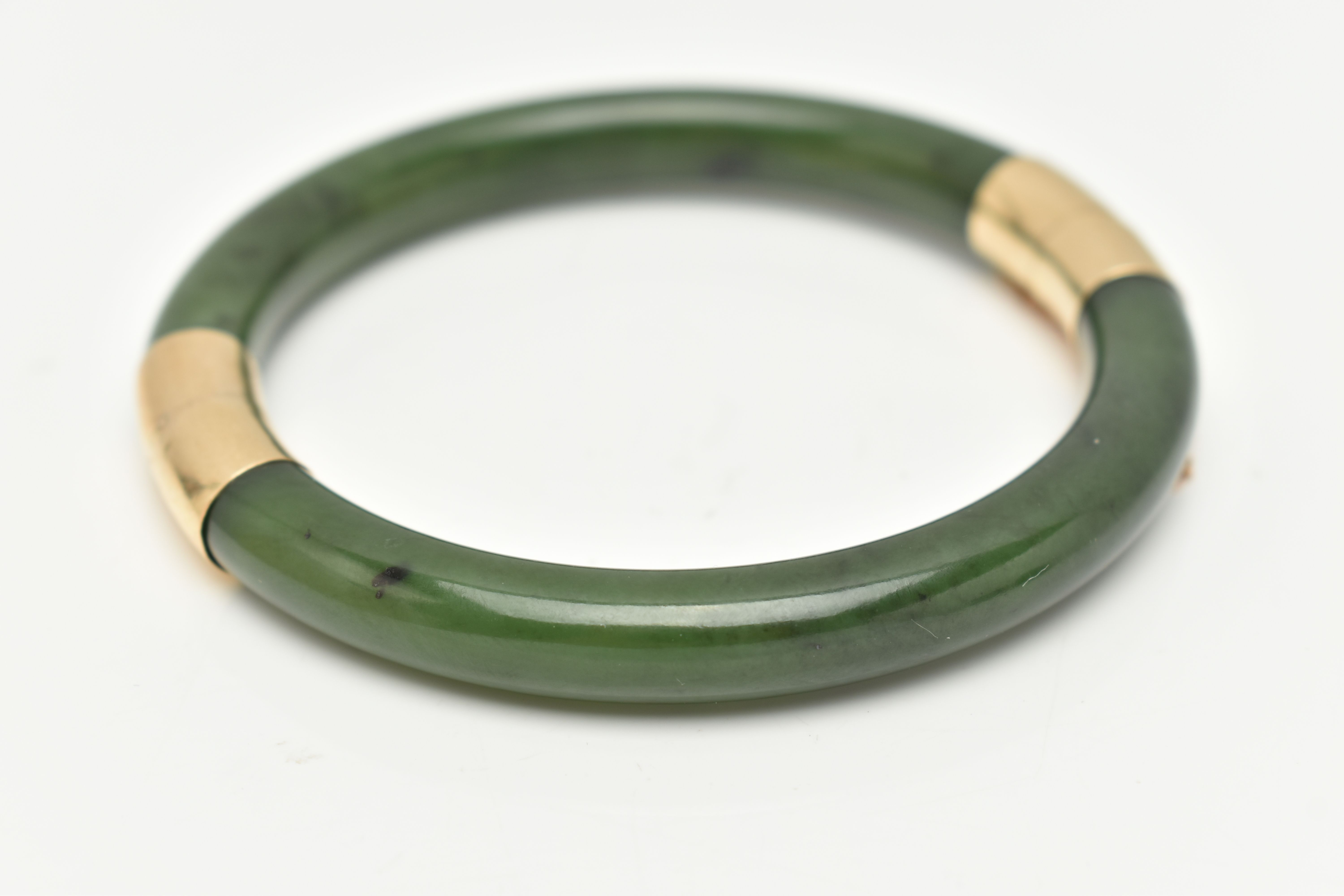 A NEPHRITE JADE BANGLE, with fittings to the hinge and clasp, safety chain attached, clasp stamped - Image 2 of 3