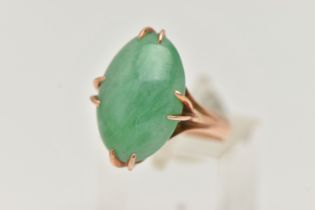 A CHINESE JADE CABOCHON RING, designed as an oval jade cabochon within an eight claw setting to
