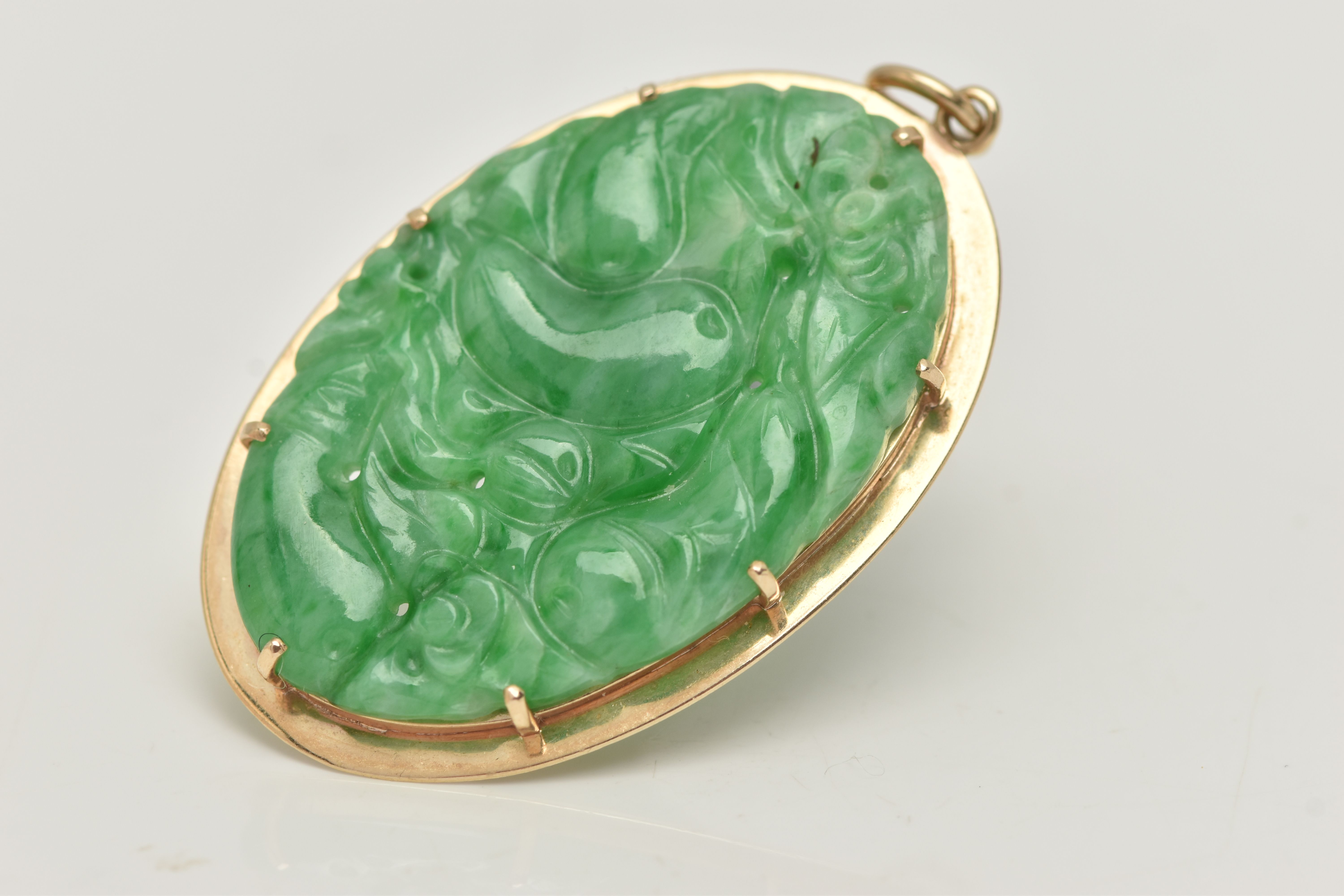 A 9CT GOLD CARVED JADE PENDANT, the oval jade panel carved to depict flowers, foliage and possibly - Image 3 of 4