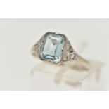 AN AQUAMARINE AND DIAMOND RING, principally set with a rectangular cut aquamarine, approximate