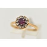 AN 18CT GOLD RUBY AND DIAMOND CLUSTER RING, of a circular form, centrally set with a circular cut