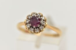AN 18CT GOLD RUBY AND DIAMOND CLUSTER RING, of a circular form, centrally set with a circular cut