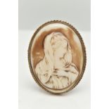 A LARGE YELLOW METAL CAMEO BROOCH, molded plastic, painted cameo possibly depicting Madonna,