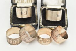 THREE SETS OF SILVER NAPKIN RINGS, to include two boxed engine turned pattern rings, engraved