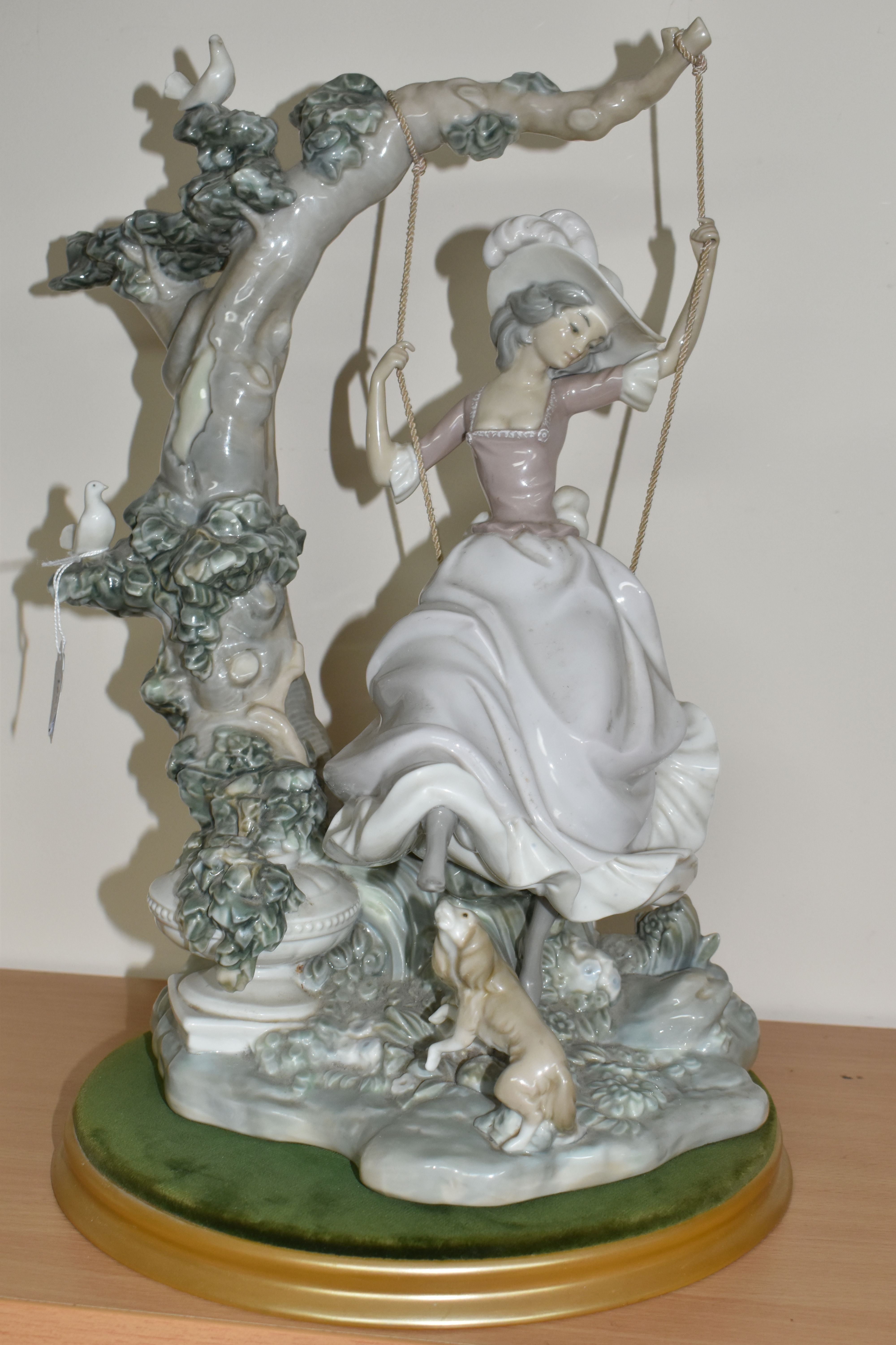 A LLADRO 'SWINGING' SCULPTURE OF A GIRL ON A SWING, model no 1297, sculptor Salvador Debon, issued