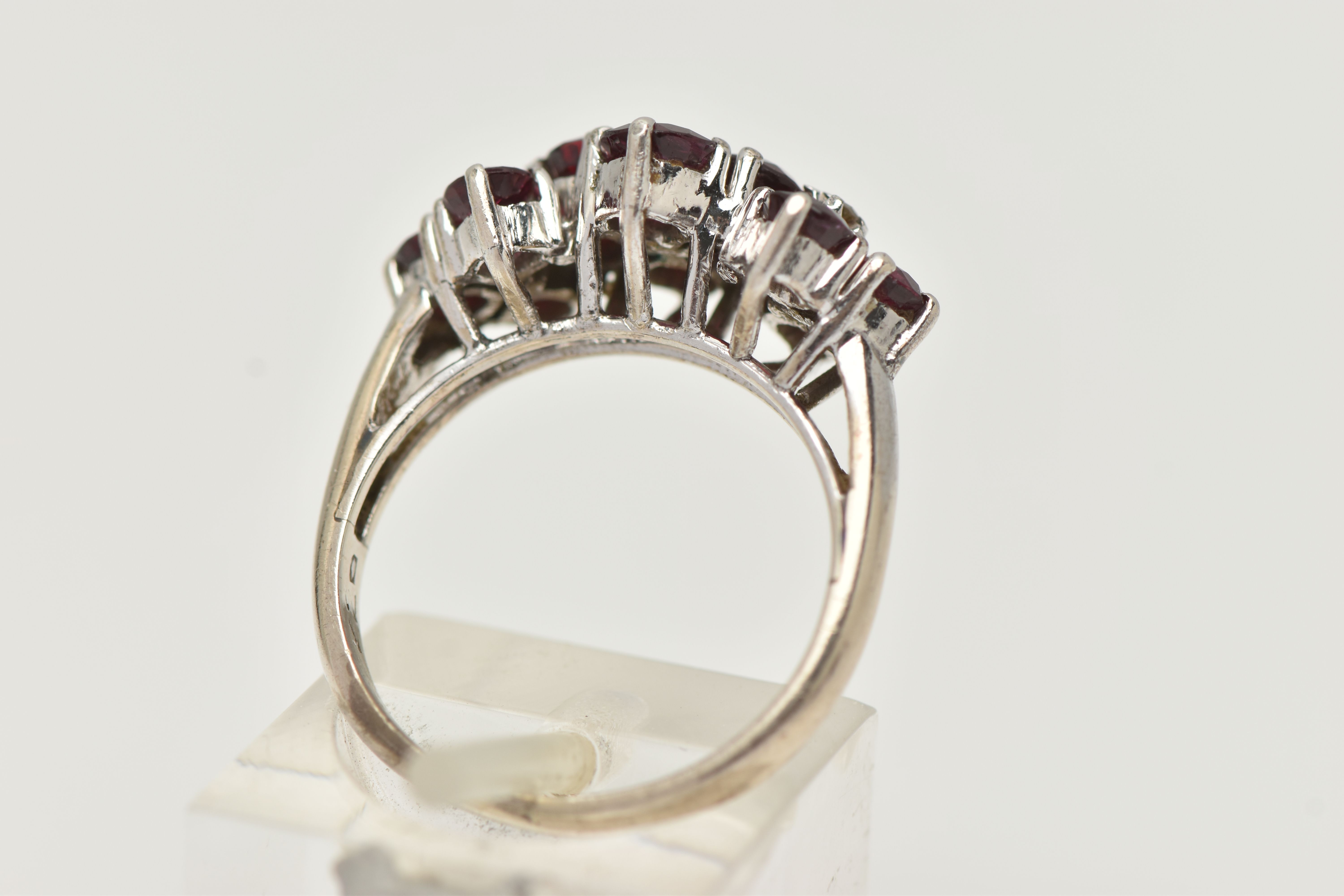 A WHITE METAL RUBY AND DIAMOND DRESS RING, set with ten circular cut rubies, each claw set, with - Image 3 of 4
