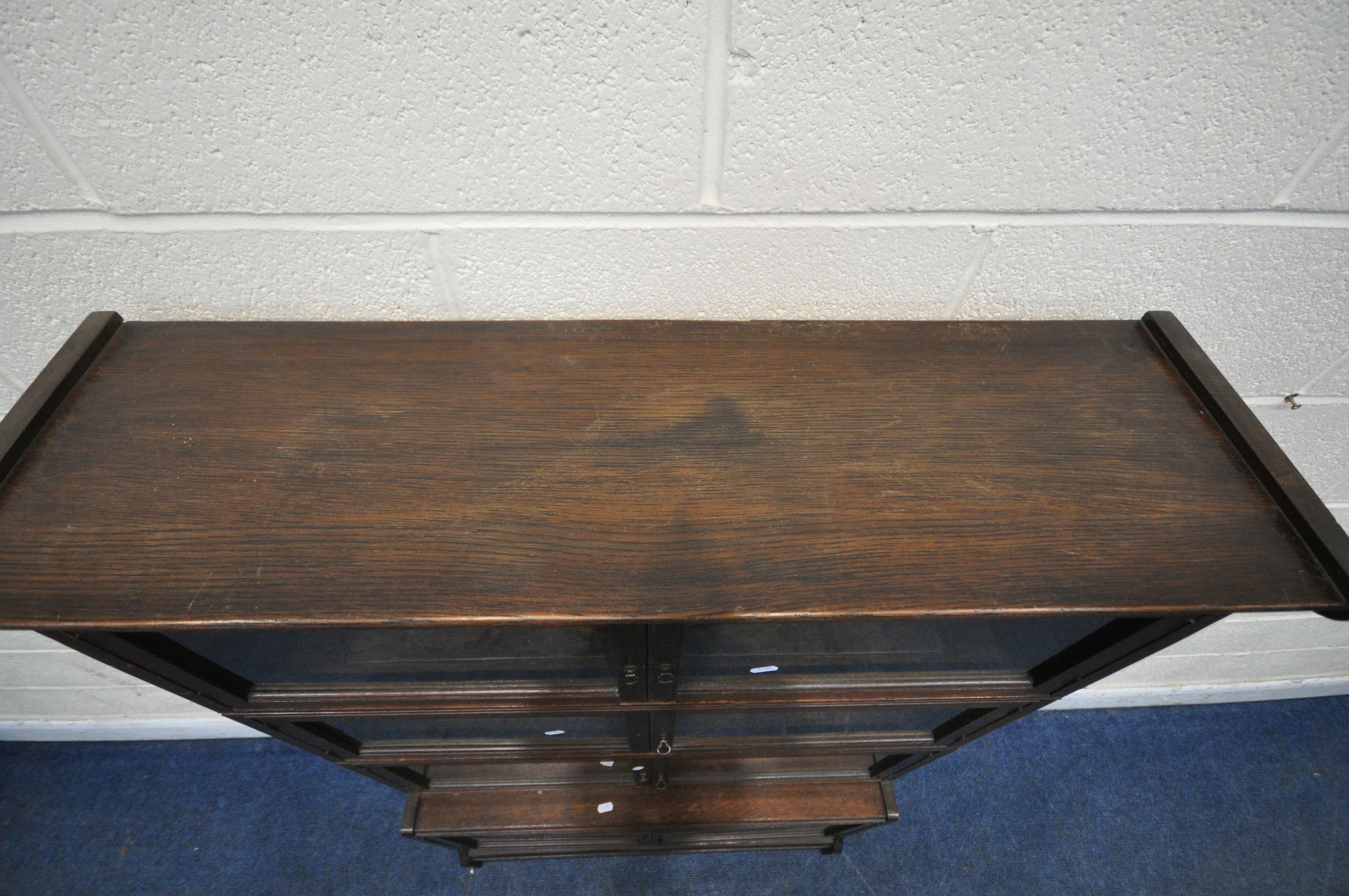 W M BAKER AND CO, OXFORD, AN EARLY 20TH CENTURY OAK SECTIONAL BOOKCASE, with one deep bottom section - Image 4 of 6