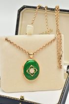 AN 18CT GOLD DIAMOND AND ENAMEL LOCKET, the oval locket with green enamel front, a quatrefoil design