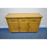 A MODERN LIGHT OAK SIDEBOARD, fitted with three drawers, above three cupboard doors, length 137cm