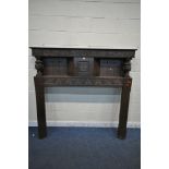 A LARGE EARLY 20TH CENTURY OAK FIRE SURROUND, with scrolled and foliate carvings, bulbous turned