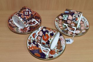 THREE ROYAL CROWN DERBY COFFEE CANS AND SAUCERS, from 'The Curator's Collection' in Rich Japan,