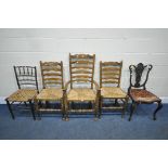 A SET OF THREE EARLY 20TH CENTURY OAK RUSH SEATED LADDER BACK CHAIRS, including one carver,