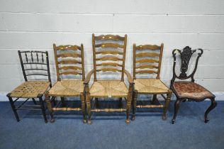 A SET OF THREE EARLY 20TH CENTURY OAK RUSH SEATED LADDER BACK CHAIRS, including one carver,