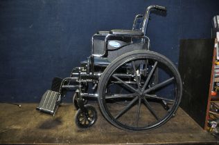 AN INVACARE TRACER EX2 FOLDING WHEELCHAIR with two footrests