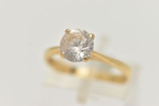 A YELLOW METAL TOPAZ RING, set with a circular cut colourless topaz, in a four claw setting, pinched