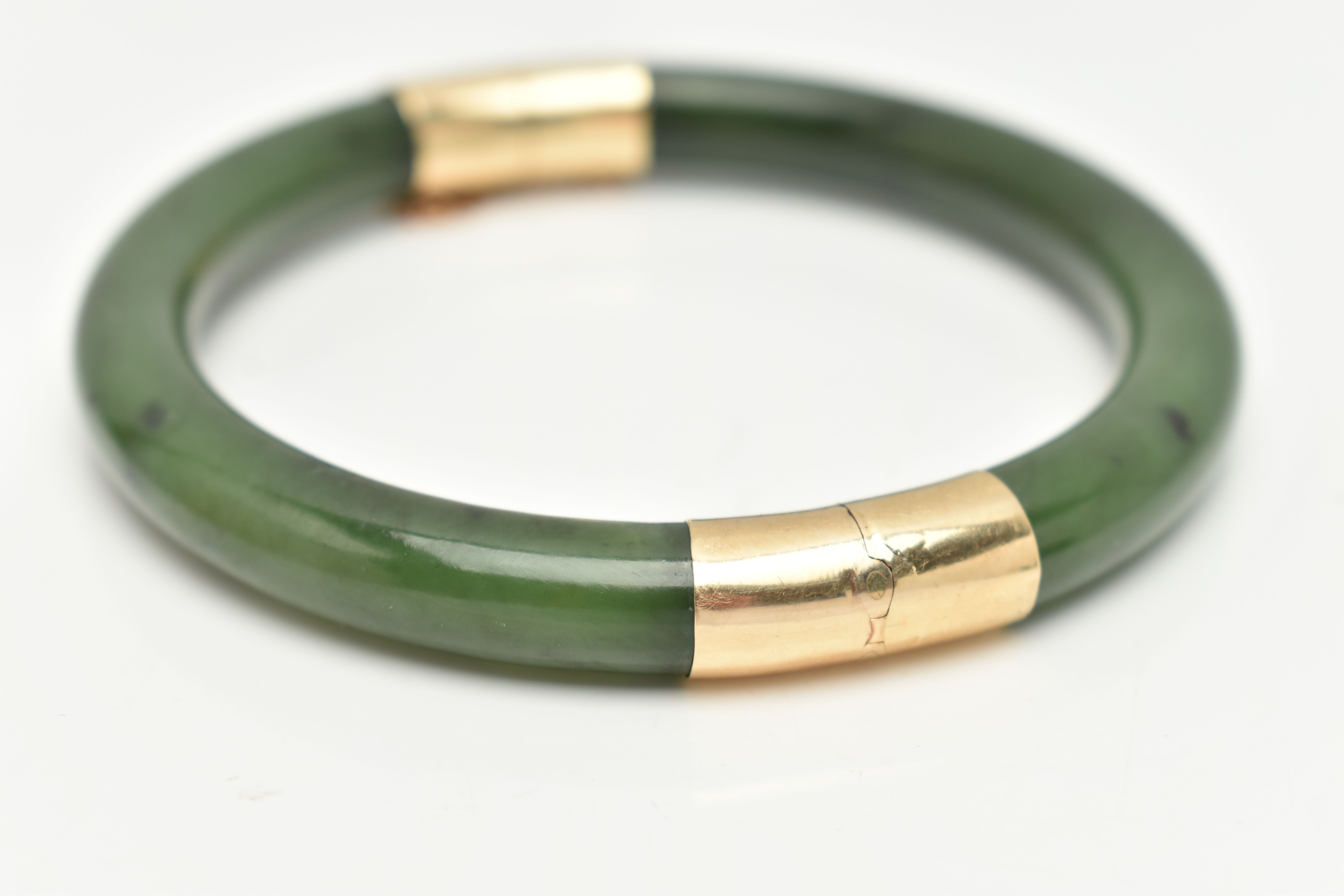 A NEPHRITE JADE BANGLE, with fittings to the hinge and clasp, safety chain attached, clasp stamped - Image 3 of 3