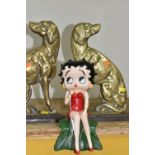 A CAST IRON FIGURE OF BETTY BOOP AND A PAIR OF BRASS SPANIEL DOORSTOPS, the painted shelf sitting