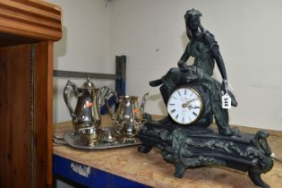 A FIGURAL MANTEL CLOCK AND AN ONEIDA PLATED TEA AND COFFEE SET, comprising a resin figural mantel