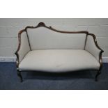 A VICTORIAN MAHOGANY SOFA, one side of backrest higher than the other, with a scrolled crest, closed