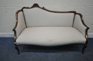 A VICTORIAN MAHOGANY SOFA, one side of backrest higher than the other, with a scrolled crest, closed
