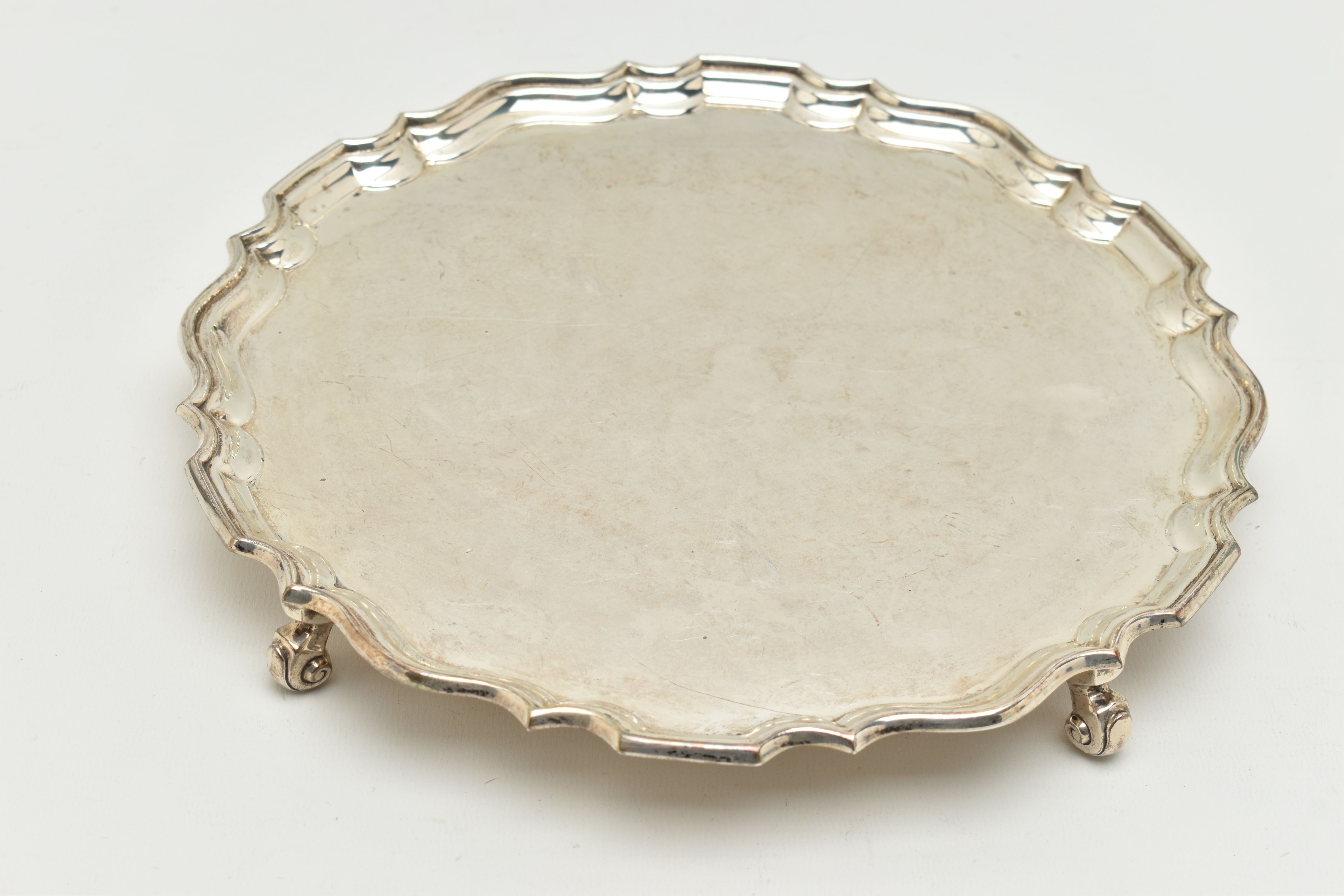 A GEORGE V SILVER SALVER, a circular form salver with a fluted border, raised on four scrolled feet, - Image 5 of 6