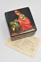 A RUSSIAN BLACK LACQUER BOX, with painted scene to the hinged lid, and Russian receipt, measuring