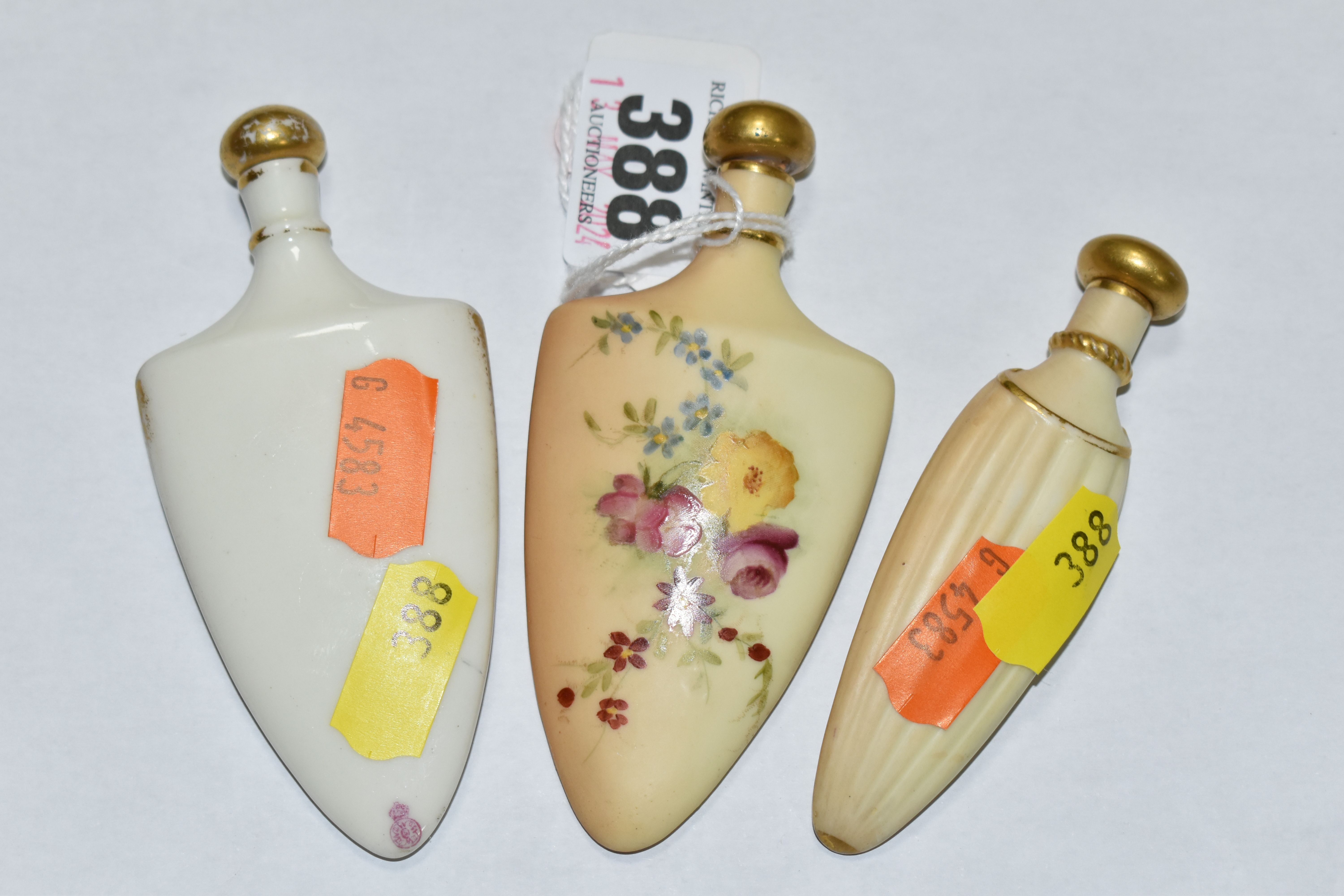 A GROUP OF THREE ROYAL WORCESTER PORCELAIN SCENT FLASKS, comprising a shield shaped bottle, hand - Image 2 of 2