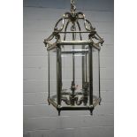 A 20TH CENTURY BRASS HEXAGONAL HALL LANTERN, the bevelled glass panes encasing a six branch light