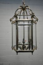 A 20TH CENTURY BRASS HEXAGONAL HALL LANTERN, the bevelled glass panes encasing a six branch light