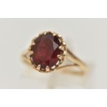 A 9CT GOLD GARNET SET RING, oval cut garnet in a double four claw setting, measuring approximately