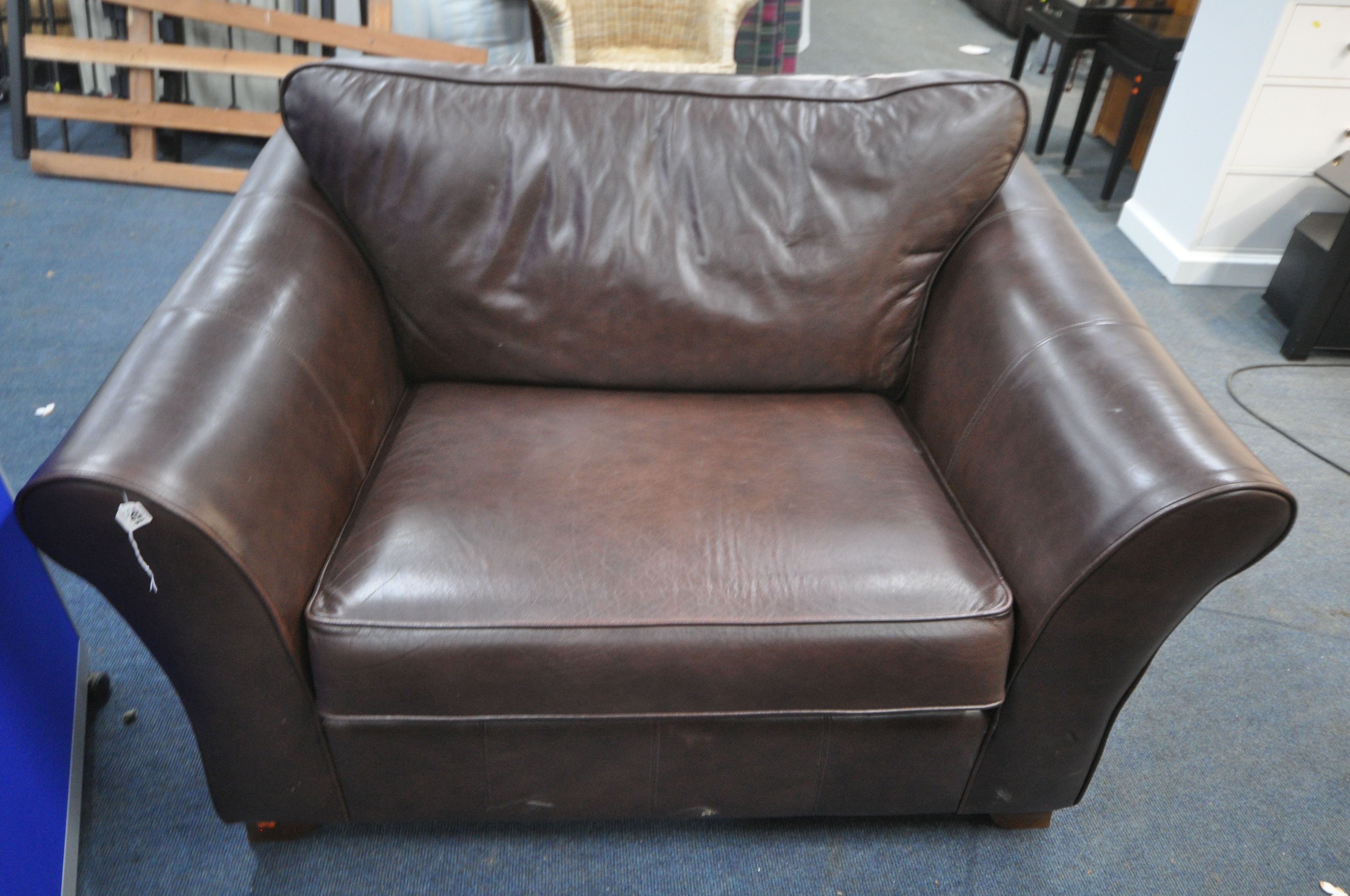 A WIDE BROWN LEATHER ARMCHAIR, width 137cm x depth 100cm, and a Parker Knoll grey leather