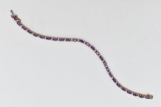 A 9CT YELLOW AND WHITE GOLD AMETHYST AND DIAMOND BRACELET, designed as a series of twenty six oval